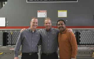 Manufacturing Executives in front of Cincinnati CNC machine